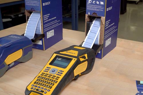 Een grote doos labels die continu in een M610 labelprinter worden ingevoerd.